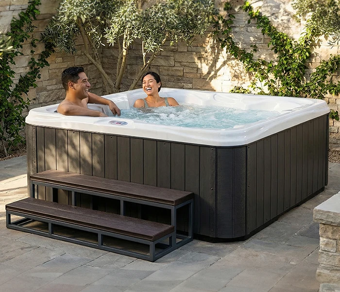 Hot Tubs, Spas, Portable Spas, for sale American Spas American Spas hot tub being used in a family setting